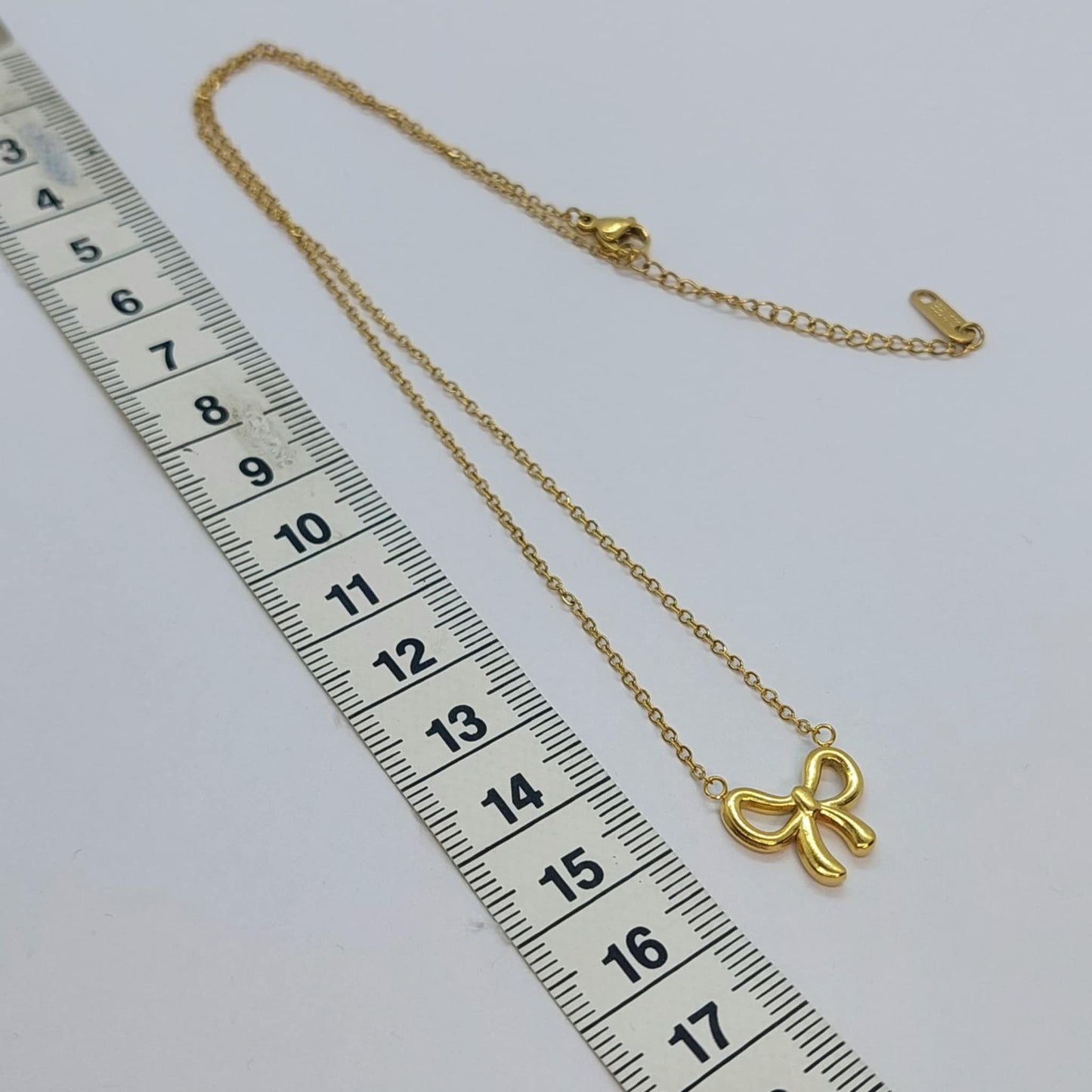 Infinity Bow Tie Pendant in Stainless Steel Gold Plated Chain Necklace