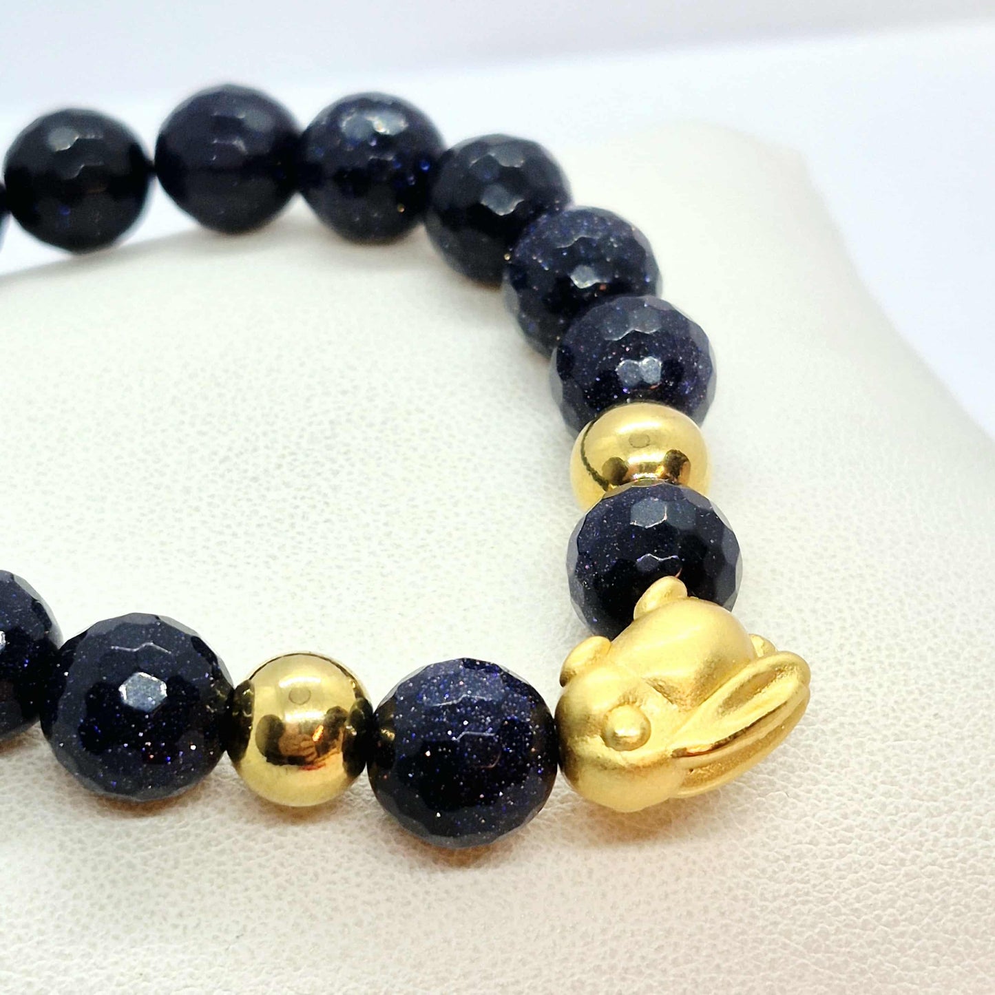 Blue Faceted Goldstone Bracelet in 10mm Stones with Silver Bunny Bead